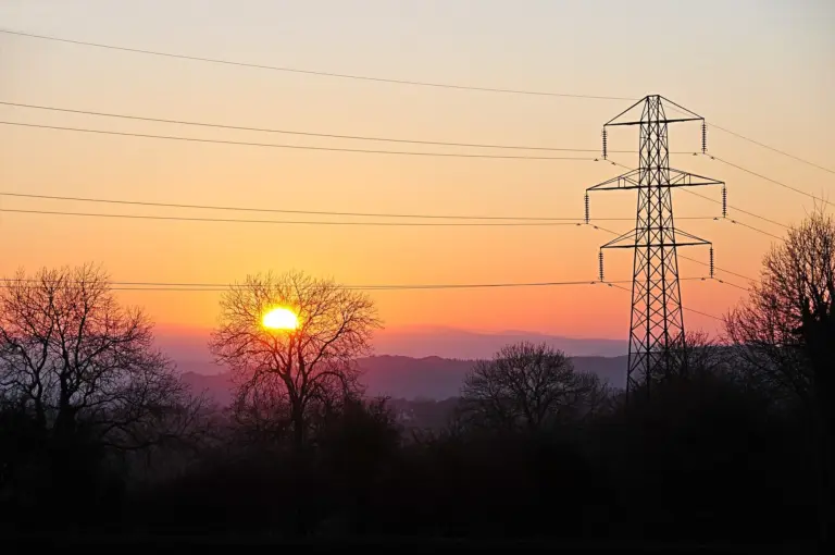 Power lines at sunset illustrating the grid demands of AI data centres